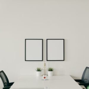 White Wooden Table With Chairs In A Room